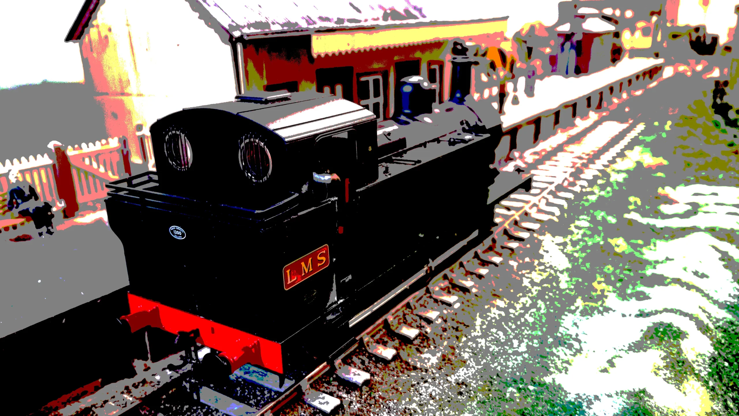 a LMS steam engin at a station on a model raliway
